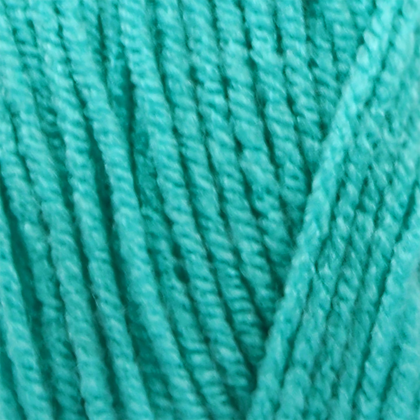 Close-up of teal yarn with a textured pattern