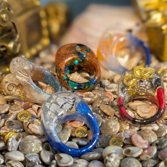 Colorful jewelry on a bed of seashells with a blurred background